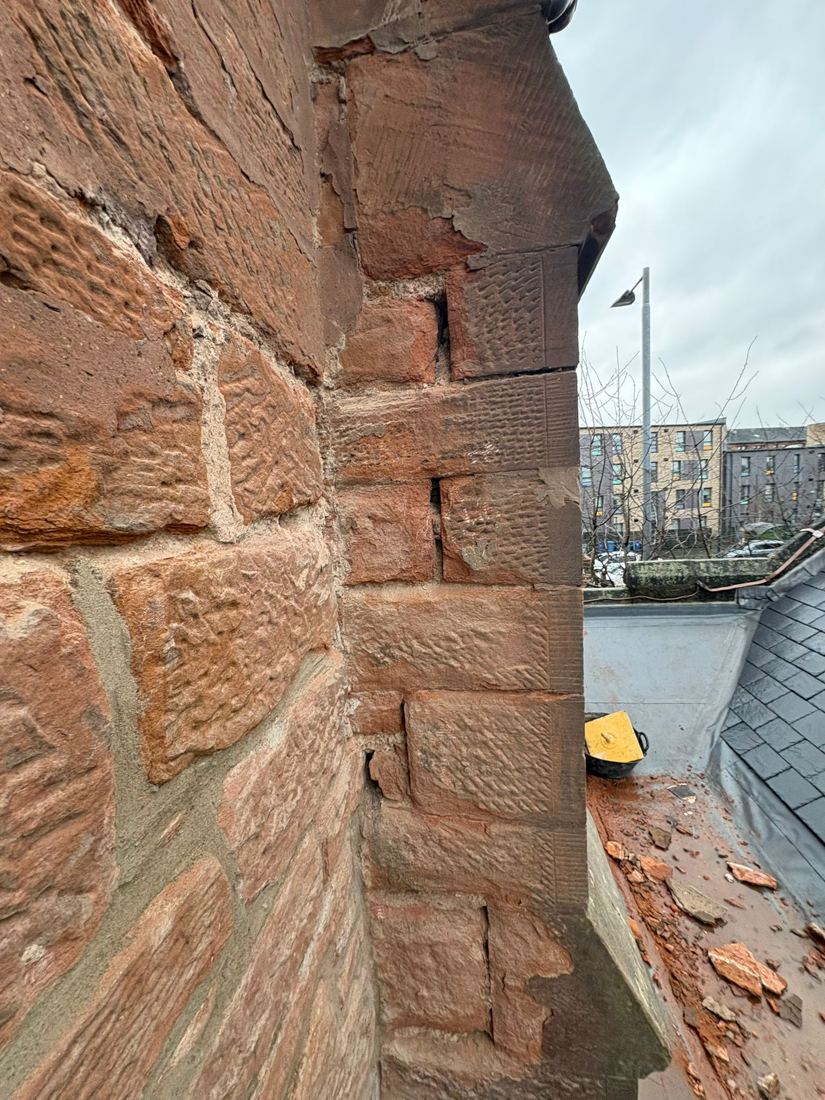 Red sandstone buttress repair against the sky
