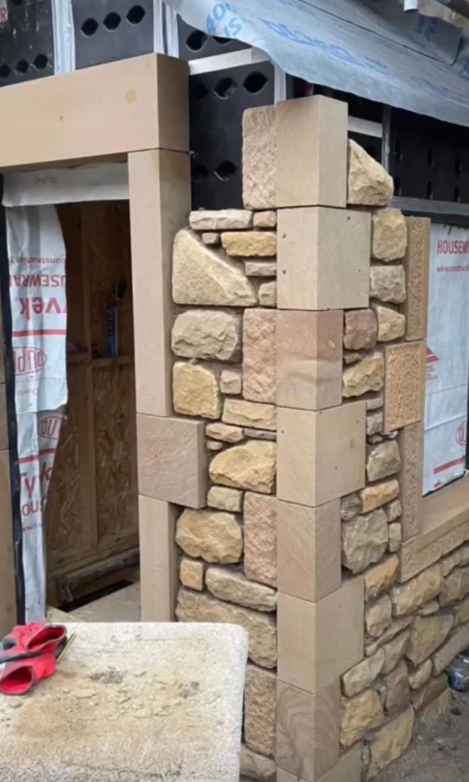 Blonde sandstone door surround under construction