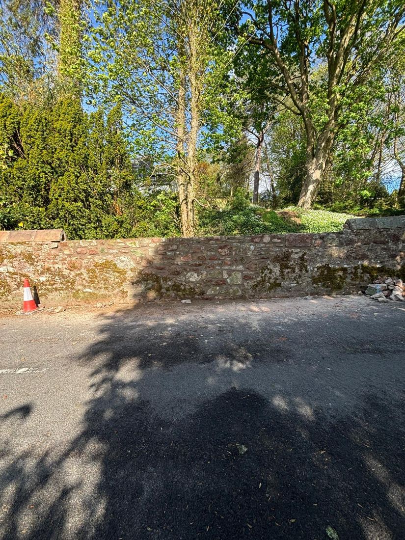 Rebuilt stone boundary wall