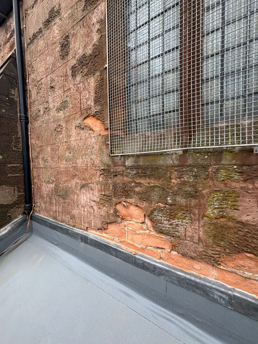 Church sandstone wall with lead flashing